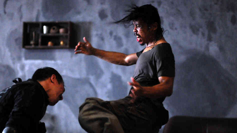 Gang enforcer Mad Dog (Yayan Ruhian, right) fights off Indonesian SWAT agent Jaka (Joe Taslim) as Jaka's team invades a Jakarta tenement controlled by a brutal gangster. Gang enforcer Mad Dog (Yayan Ruhian, right) fights off Indonesian SWAT agent Jaka (Joe Taslim) as Jaka's team invades a Jakarta tenement controlled by a brutal gangster.
