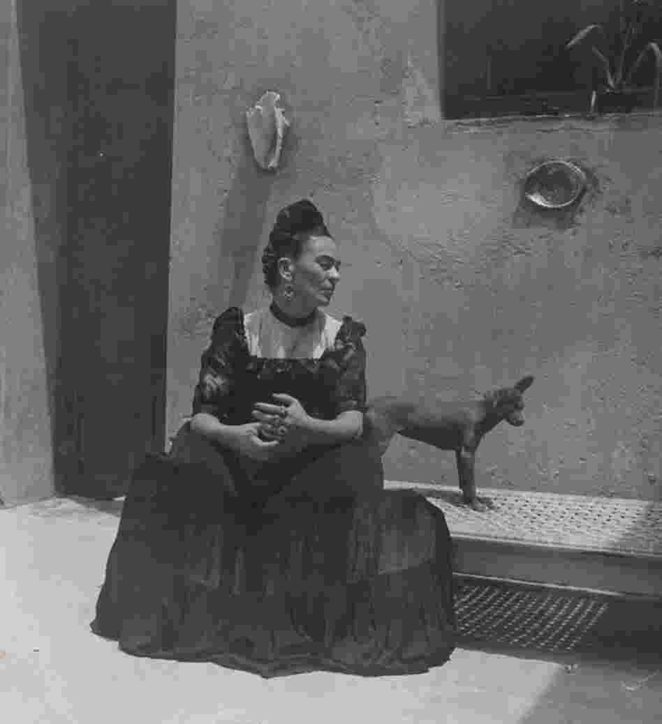 Frida Kahlo seated with dog, circa 1944. 