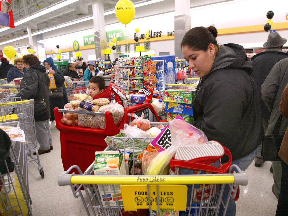 Concepsion Alcantar-Alvarez looks through her cart in the check-out line at a Food 4 Less store in Chicago.