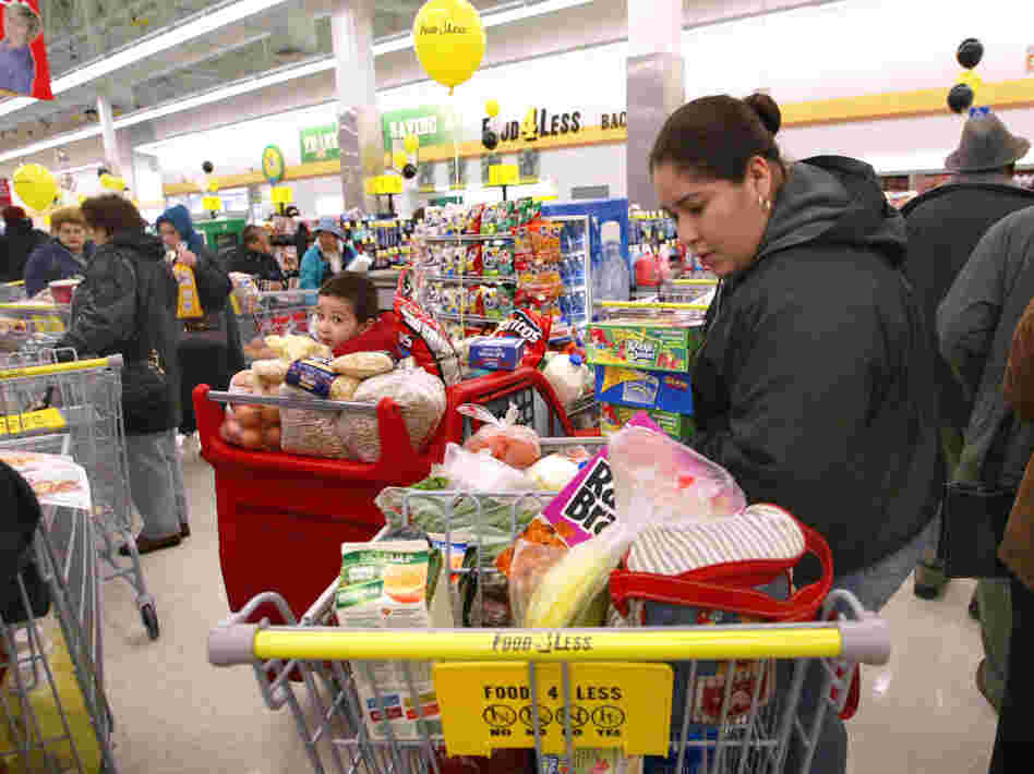 Concepsion Alcantar-Alvarez looks through her cart in the check-out line at a Food 4 Less store in Chicago.