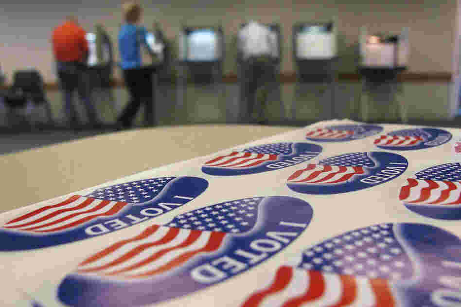 Voters fill out ballots in Urbana, Ill., on Tuesday. White House hopeful Mitt Romney was eyeing a big win in President Obama's home state. 