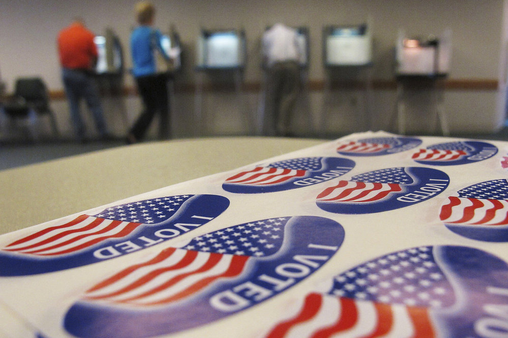 Voters fill out ballots in Urbana, Ill., on Tuesday. White House hopeful Mitt Romney was eyeing a big win in President Obama's home state. 