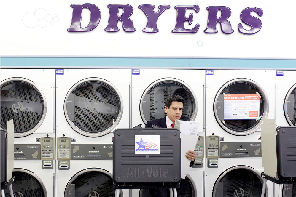 A voter prepares to cast his vote in the state primary at a laundromat in Chicago. There are 54 GOP delegates up for grabs in Illinois. 