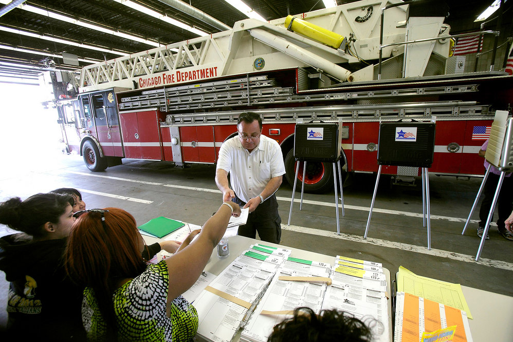 A man picks up a ballot at a Chicago fire station. The GOP's incremental delegate race has put an unexpected spotlight on the Illinois primary. 