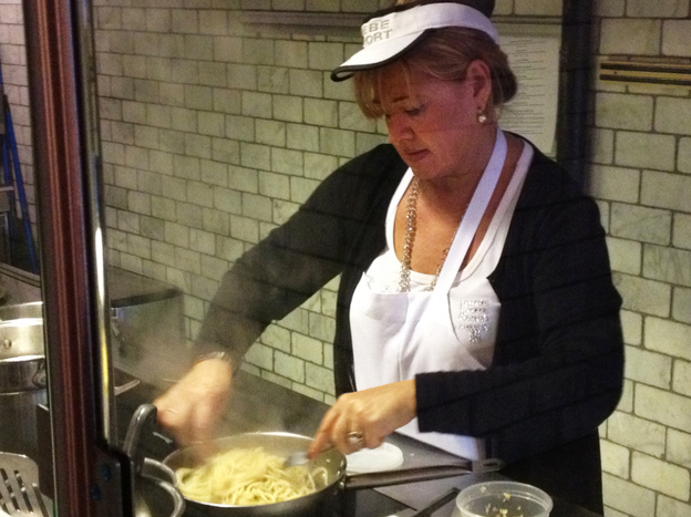 Enoteca Maria "nonna" Giovana Gambino prepares a dish in the restaurant's kitchen. 