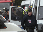 Police officers stand near the apartment building where a suspect in the shooting at the Ozar Hatorah Jewish school is barricaded in Toulouse, southern France on Wednesday. Police officers stand near the apartment building where a suspect in the shooting at the Ozar Hatorah Jewish school is barricaded in Toulouse, southern France on Wednesday.