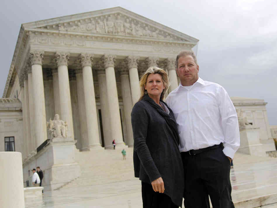 Mike and Chantell Sackett of Priest Lake, Idaho, pose for a photo in front of the Supreme Court in Washington on Oct. 14, 2011. The court ruled unanimously Wednesday that property owners have a right to prompt review by a judge of an important tool used by the Environmental Protection Agency to address water pollution.