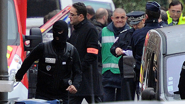 French police officers at the scene of the siege today in Toulouse, where a suspect in recent killings is said to be holed up in an apartment. 