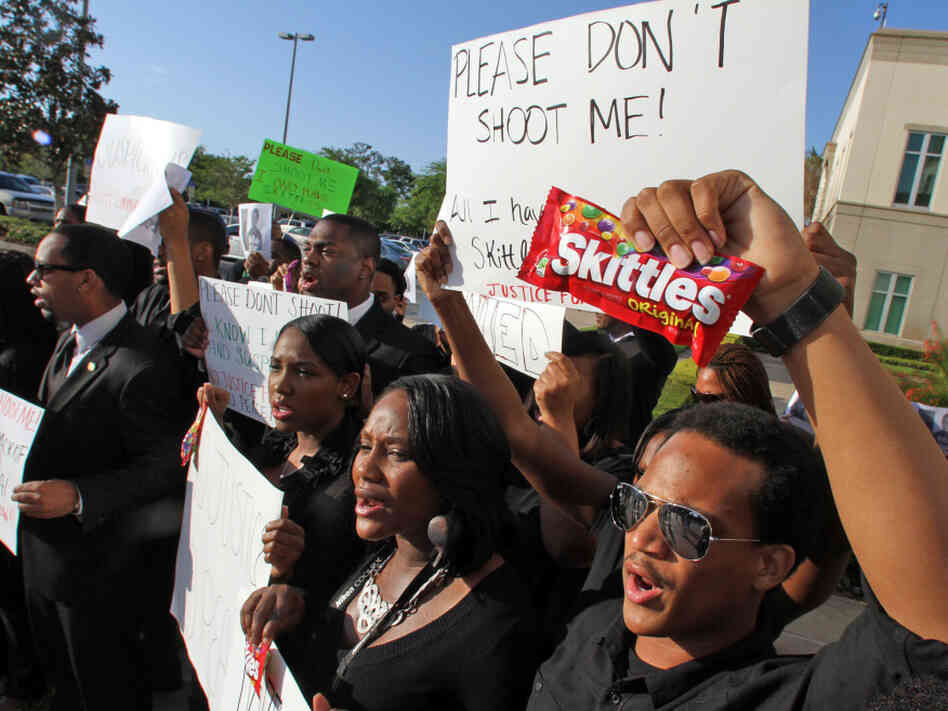 Brandon Northington (right) a FAMU law student chants, "Do I look suspicious?" while holding a bag of Skittles during a rally Monday at the Seminole County Courthouse in Sanford, Fla. Trayvon Martin was holding the candy when he was shot and killed.