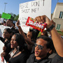 Brandon Northington (right) a FAMU law student chants, "Do I look suspicious?" while holding a bag of Skittles during a rally Monday at the Seminole County Courthouse in Sanford, Fla. Trayvon Martin was holding the candy when he was shot and killed. Brandon Northington (right) a FAMU law student chants, "Do I look suspicious?" while holding a bag of Skittles during a rally Monday at the Seminole County Courthouse in Sanford, Fla. Trayvon Martin was holding the candy when he was shot and killed.
