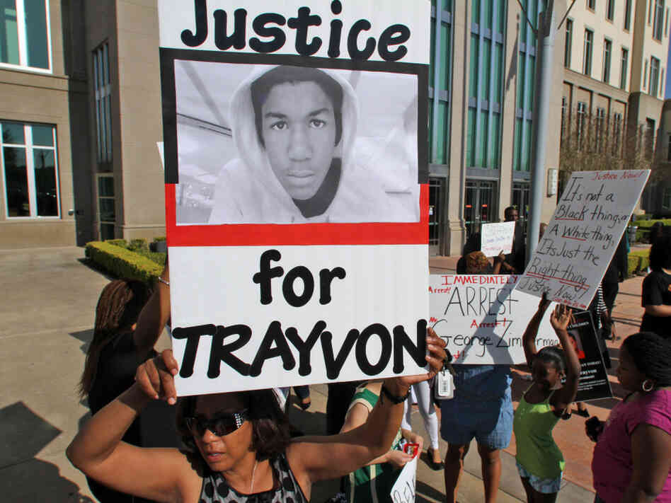 Demonstrators rally at the Seminole County Courthouse on Monday, demanding the arrest of a neighborhood watch captain who shot Martin, an unarmed black teen, last month.