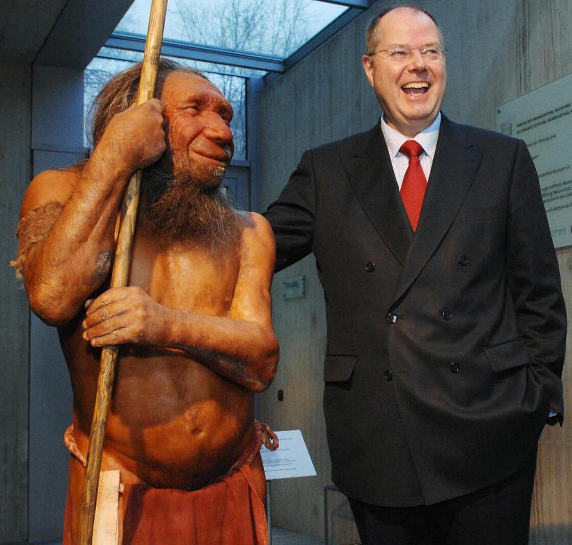 What if we still stood side-by-side? Former German Finance Minister Peer Steinbrueck poses next to a Neanderthal model at the Neanderthal Museum in Mettmann, Germany, in 2007.