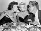 Lana Turner, center, is an interested listener as actress Ava Gardner leans over her to chat with Fernando Lamas, who is famous for saying, "It's better to look good, than feel good." Lana Turner, center, is an interested listener as actress Ava Gardner leans over her to chat with Fernando Lamas, who is famous for saying, "It's better to look good, than feel good."