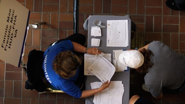 A Fannie Mae/Freddie Mac mortgage services representative (left) helps a person register for mortgage help in Miami. A Fannie Mae/Freddie Mac mortgage services representative (left) helps a person register for mortgage help in Miami.
