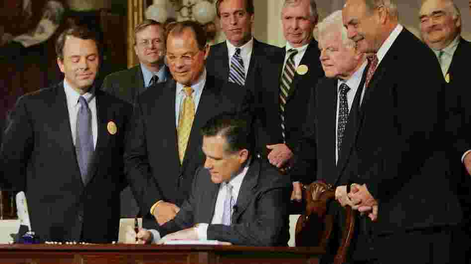 Massachusetts Gov. Mitt Romney signs into law a new health care reform bill during an April 12, 2006, ceremony at Faneuil Hall in Boston. The bill made Massachusetts the first state in the country to require that all residents have health insurance and has become a centerpiece of criticisms leveled by Romney's opponents in the 2012 presidential race. 
