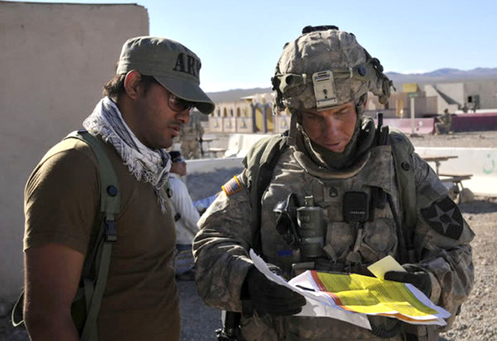 This August 23, 2011 photograph obtained courtesy of the Defense Video & Imagery Distribution System (DVIDS) shows Staff Sgt. Robert Bales (right) at the National Training Center in Fort Irwin, California. (Note at 10:50 p.m. ET: Earlier, we mistakenly said he was on the left.)