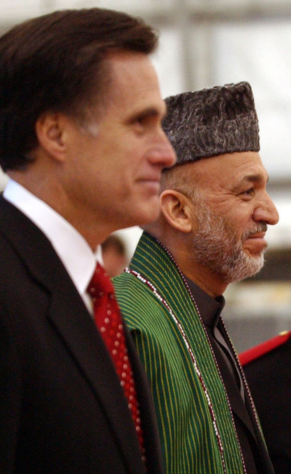 Then-Massachusetts Gov. Mitt Romney greets Afghan President Hamid Karzai on May 21, 2005, at Logan Airport in Boston. 
