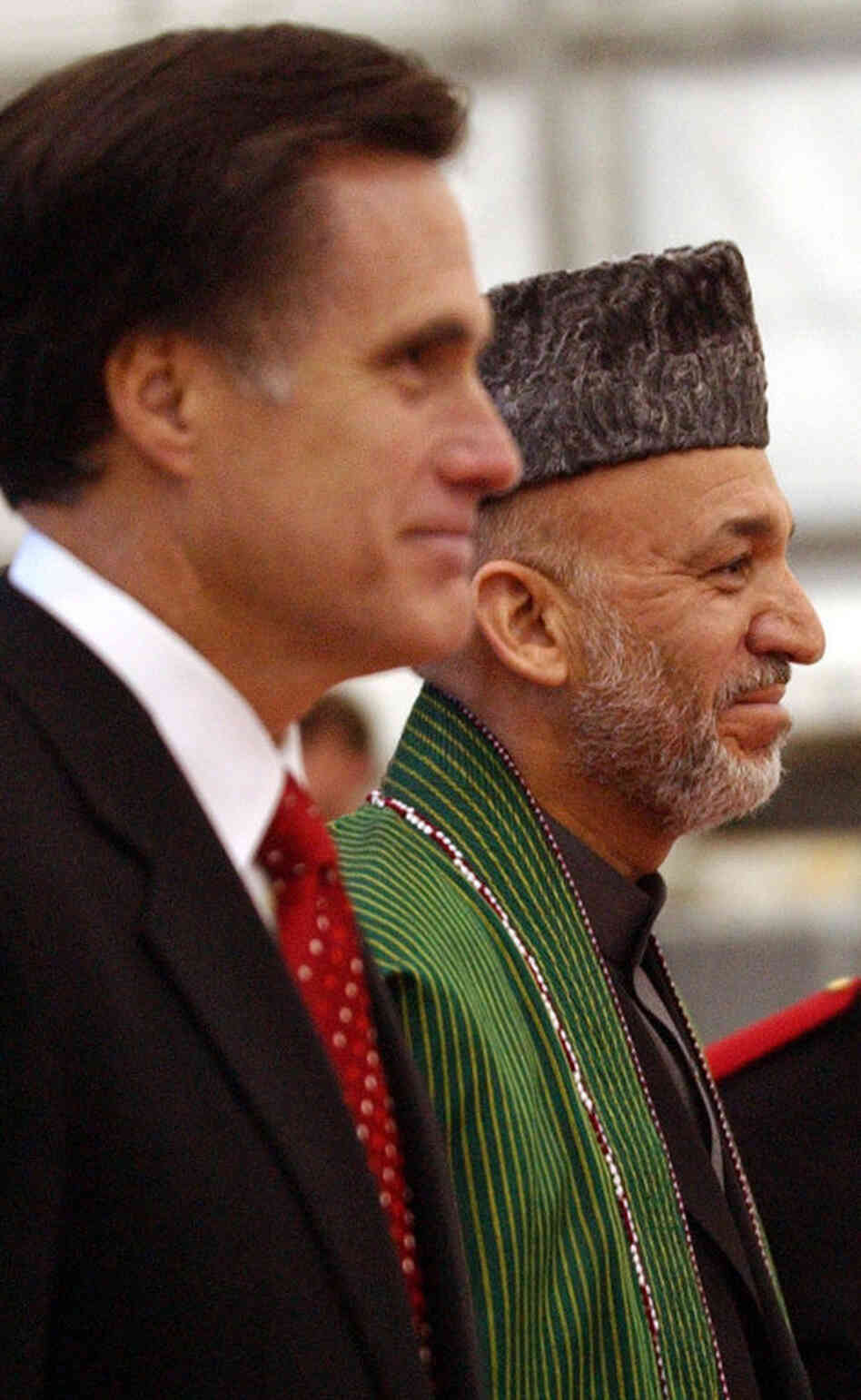 Then-Massachusetts Gov. Mitt Romney greets Afghan President Hamid Karzai on May 21, 2005, at Logan Airport in Boston. 