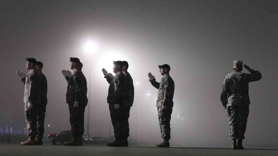 An Army carry team salutes a vehicle containing the remains of an American soldier killed in Afghanistan on March 17, at Dover Air Force Base in Dover, Del.