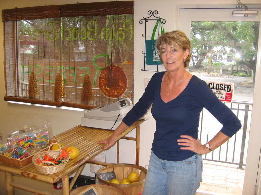 Louisa McQueeney manages a small business in Lantana, Fla., shipping gift food and produce. She believes the new health care law could bring down her employee health care costs, but Florida Gov. Rick Scott disagrees, and he's leading the battle to strike down the law in court. 