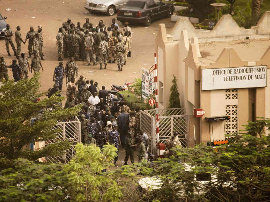 Soldiers gather at the offices of the state radio and television broadcaster after announcing a coup in Mali's capital, Bamako, on Thursday. The soldiers said they ousted the president because he wasn't doing enough to halt a rebel insurgency.
