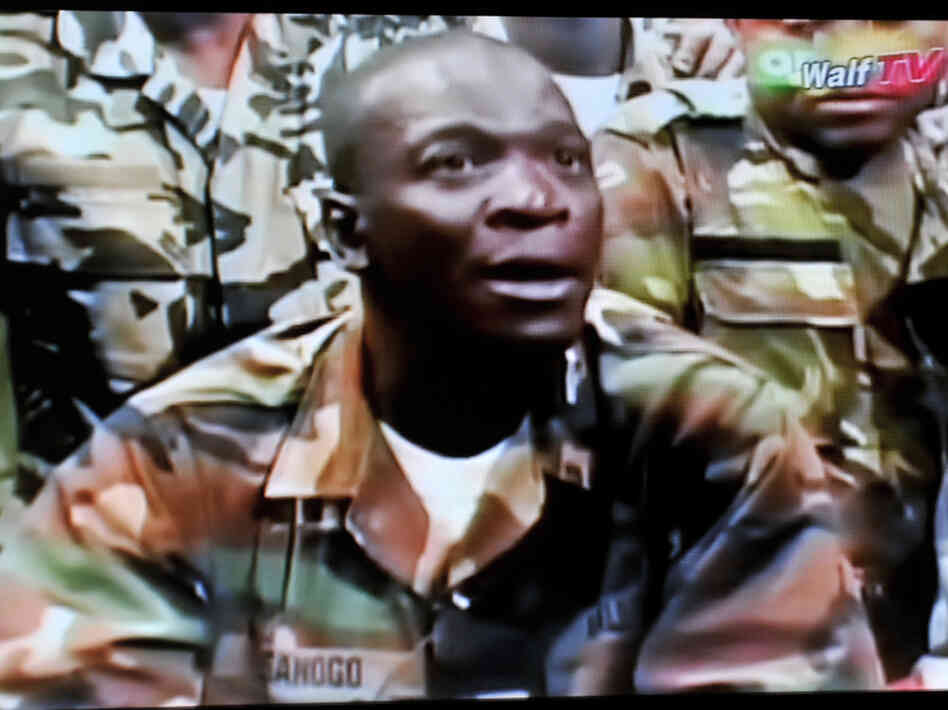 The leader of the junta that seized power in Mali, Army Capt. Amadou Sanogo, announces a curfew in the capital, Bamako, on Thursday, in this photo taken from television.The coup ousted an elected president who was due to step down after a new election next month in the West African nation.