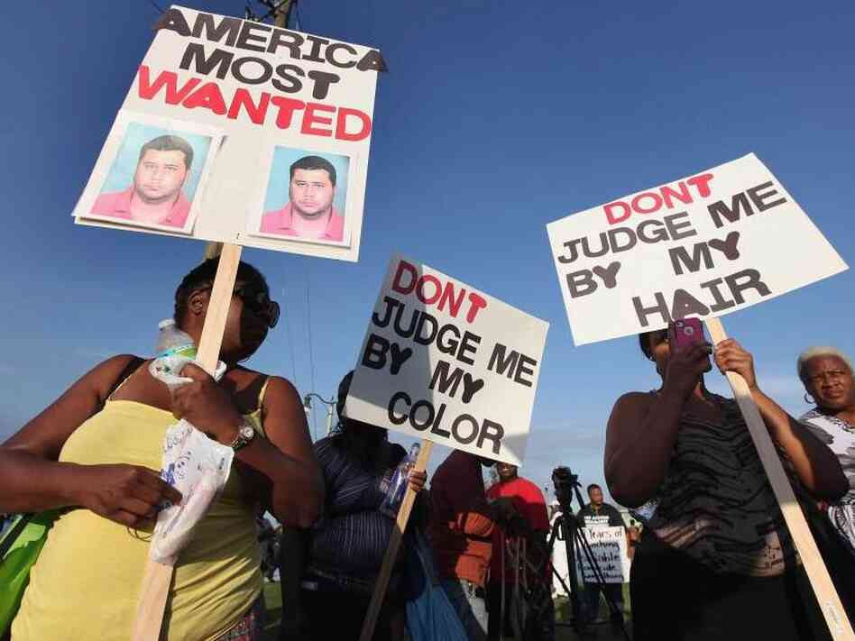 Protesters demonstrate at a rally for slain teenager Trayvon Martin on March 22, 2012 in Sanford, Fla.
