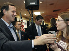 Rick Santorum takes the phone to speak to a supporter's husband, who couldn't attend a Shreveport, La., rally, on Friday. Rick Santorum takes the phone to speak to a supporter's husband, who couldn't attend a Shreveport, La., rally, on Friday.