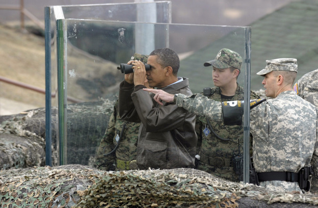 President Obama looks toward North Korea from a post on the South Korean side of the DMZ, the tense military border between the two Koreas, on Sunday. At right is U.S. Lt. Col. Ed Taylor, commander of the U.N. Command Security Battalion-Joint Security Area. President Obama looks toward North Korea from a post on the South Korean side of the DMZ, the tense military border between the two Koreas, on Sunday. At right is U.S. Lt. Col. Ed Taylor, commander of the U.N. Command Security Battalion-Joint Security Area.
