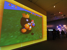 A large video screen shows a scene from Super Mario Bros. at the exhibition "The Art of Video Games." A large video screen shows a scene from Super Mario Bros. at the exhibition "The Art of Video Games."