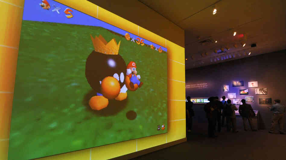 A large video screen shows a scene from Super Mario Bros. at the exhibition "The Art of Video Games." A large video screen shows a scene from Super Mario Bros. at the exhibition "The Art of Video Games."