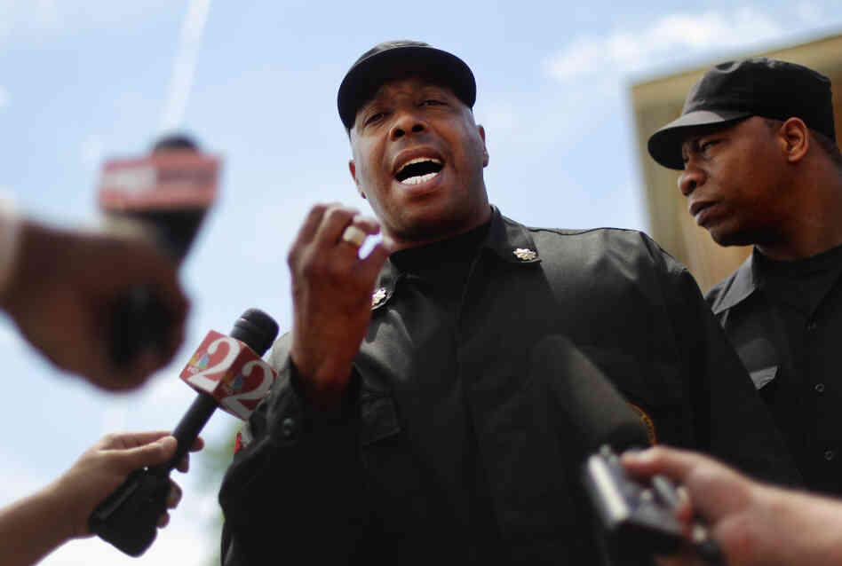 Mikhail Muhammad of the New Black Panther Party speaks to the media next to a memorial to Trayvon Martin outside The Retreat at Twin Lakes community where Trayvon was shot and killed by George Michael Zimmerman.