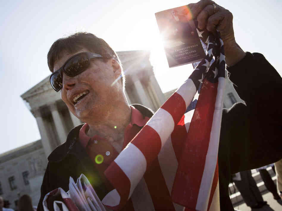 A protester holds up a copy of the U.S. Constitution outside the Supreme Court on Monday in Washington, D.C.