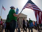 Demonstrators in support of President Obama's health care overhaul march outside the U.S. Supreme Court on Monday. Demonstrators in support of President Obama's health care overhaul march outside the U.S. Supreme Court on Monday.