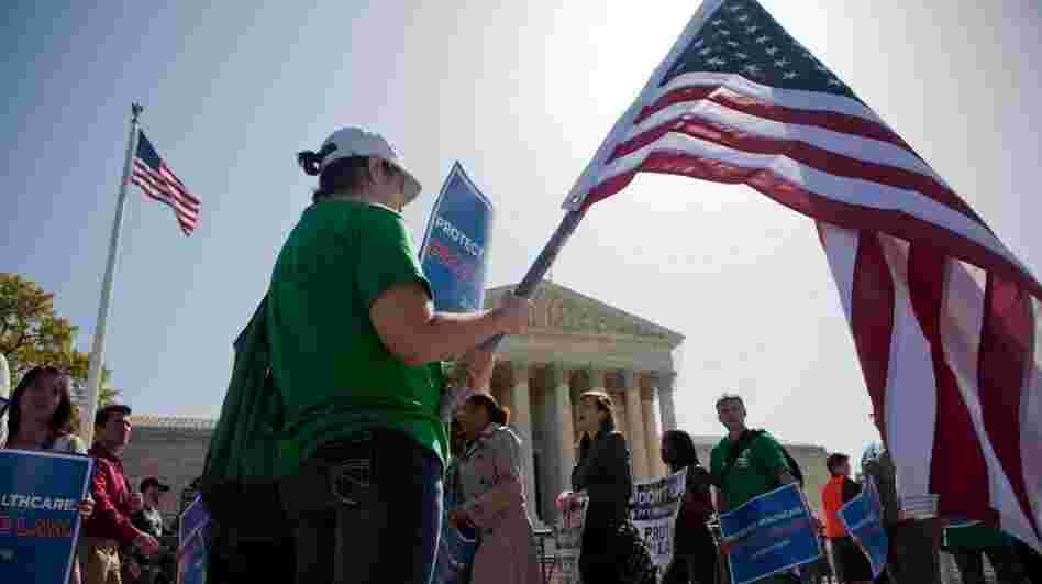 Demonstrators in support of President Obama's health care overhaul march outside the U.S. Supreme Court on Monday. 