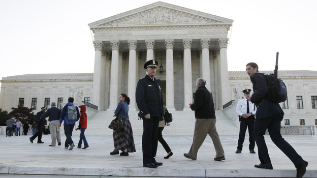 Members of the public line up Monday morning as the Supreme Court begins three days of arguments on the health care overhaul law signed by President Obama in Washington.