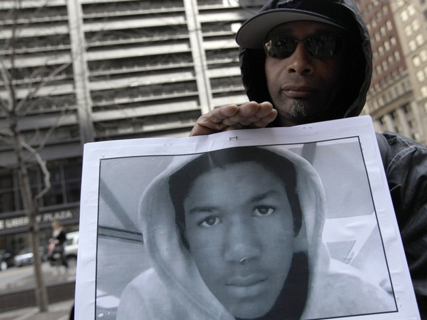 Steven Bishop, of Raleigh, N.C. holds a photo of Trayvon Martin during an Occupy Wall Street march and rally on Saturday (March 24, 2012) in New York City.