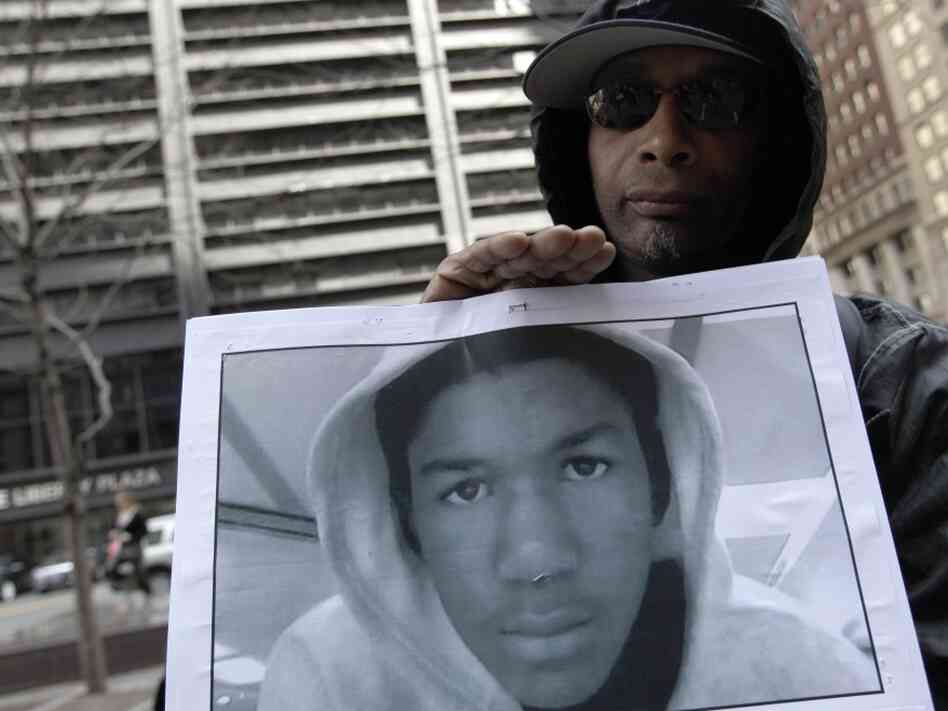Steven Bishop, of Raleigh, N.C. holds a photo of Trayvon Martin during an Occupy Wall Street march and rally on Saturday (March 24, 2012) in New York City.