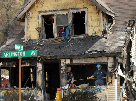 On Saturday, investigators sifted through debris in the aftermath of a house fire in Charleston, W.Va., that has now claimed nine lives. On Saturday, investigators sifted through debris in the aftermath of a house fire in Charleston, W.Va., that has now claimed nine lives.