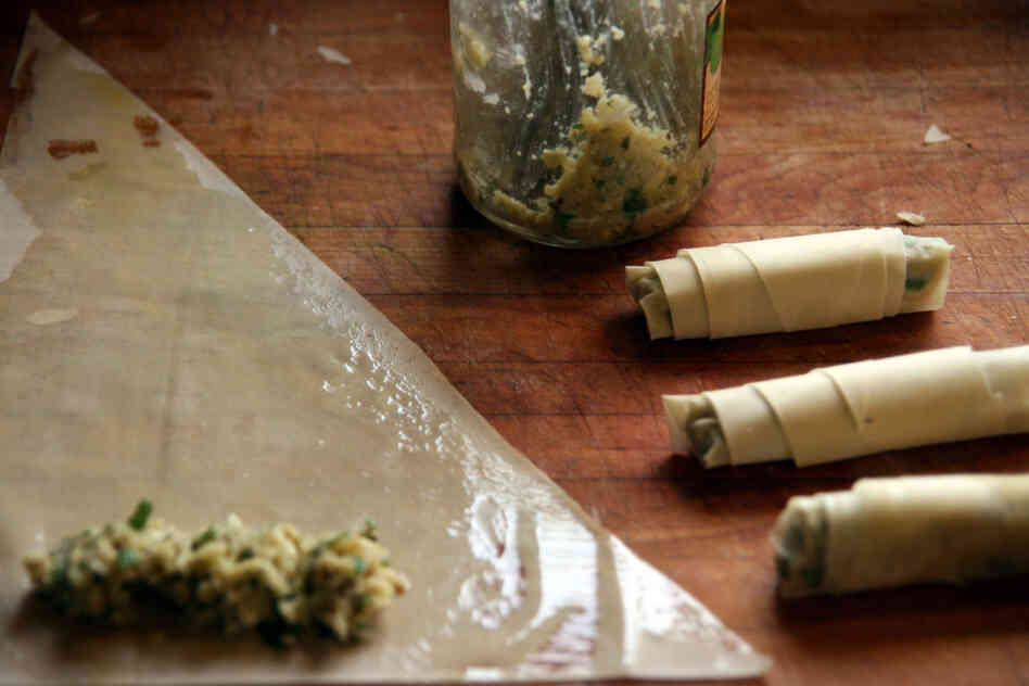The artichoke and cheese filling is rolled up in a triangle of phyllo.