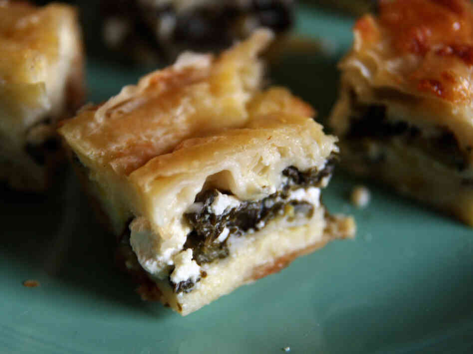 Creamy Phyllo Spinach Borek: This rich borek is sliced into small squares for serving.