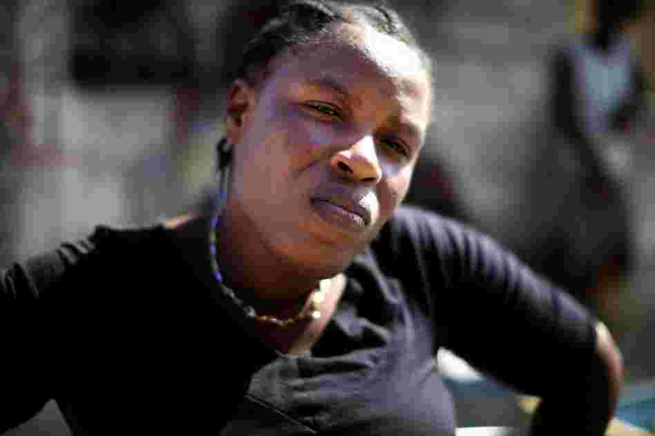 Nadia Simone stands in front of her house in Cite de Dieu. She says she has been trying to get a trash-clogged ditch next to her house drained because she knows it brings cholera right to her doorstep. Last year cholera made her young daughter very sick. "I don't want cholera to come back to my house," she says.