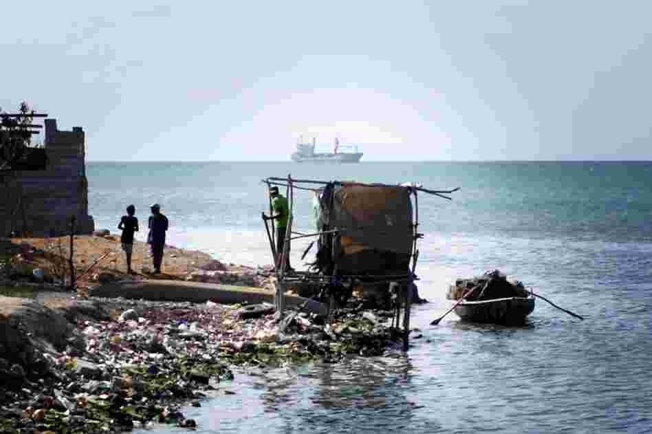 A makeshift latrine hangs over Port-au-Prince Bay at the edge of Cite de Dieu.
