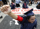 A protester blocks an Atlanta street during a rally protesting Georgia's new immigration law in June 2011. Now, the state's lawmakers are considering a bill that would also ban students here illegally from attending all public colleges. A protester blocks an Atlanta street during a rally protesting Georgia's new immigration law in June 2011. Now, the state's lawmakers are considering a bill that would also ban students here illegally from attending all public colleges.