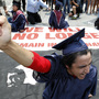 A protester blocks an Atlanta street during a rally protesting Georgia's new immigration law in June 2011. Now, the state's lawmakers are considering a bill that would also ban students here illegally from attending all public colleges. A protester blocks an Atlanta street during a rally protesting Georgia's new immigration law in June 2011. Now, the state's lawmakers are considering a bill that would also ban students here illegally from attending all public colleges.