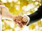 A couple holds hands. 