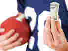 Football player holding football and cash