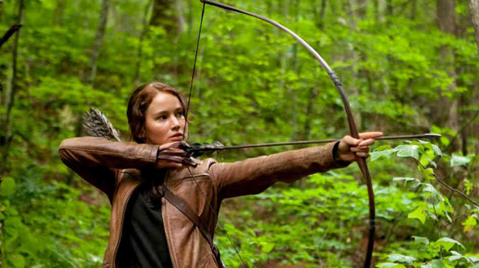Jennifer Lawrence aims an arrow in The Hunger Games. The central character of the film based on Suzanne Collins' books relies on her ability with a bow to survive.