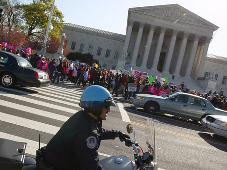 While some reporters inside scrambled to get word out, there were plenty of protesters and spectators outside the Supreme Court this morning. While some reporters inside scrambled to get word out, there were plenty of protesters and spectators outside the Supreme Court this morning.