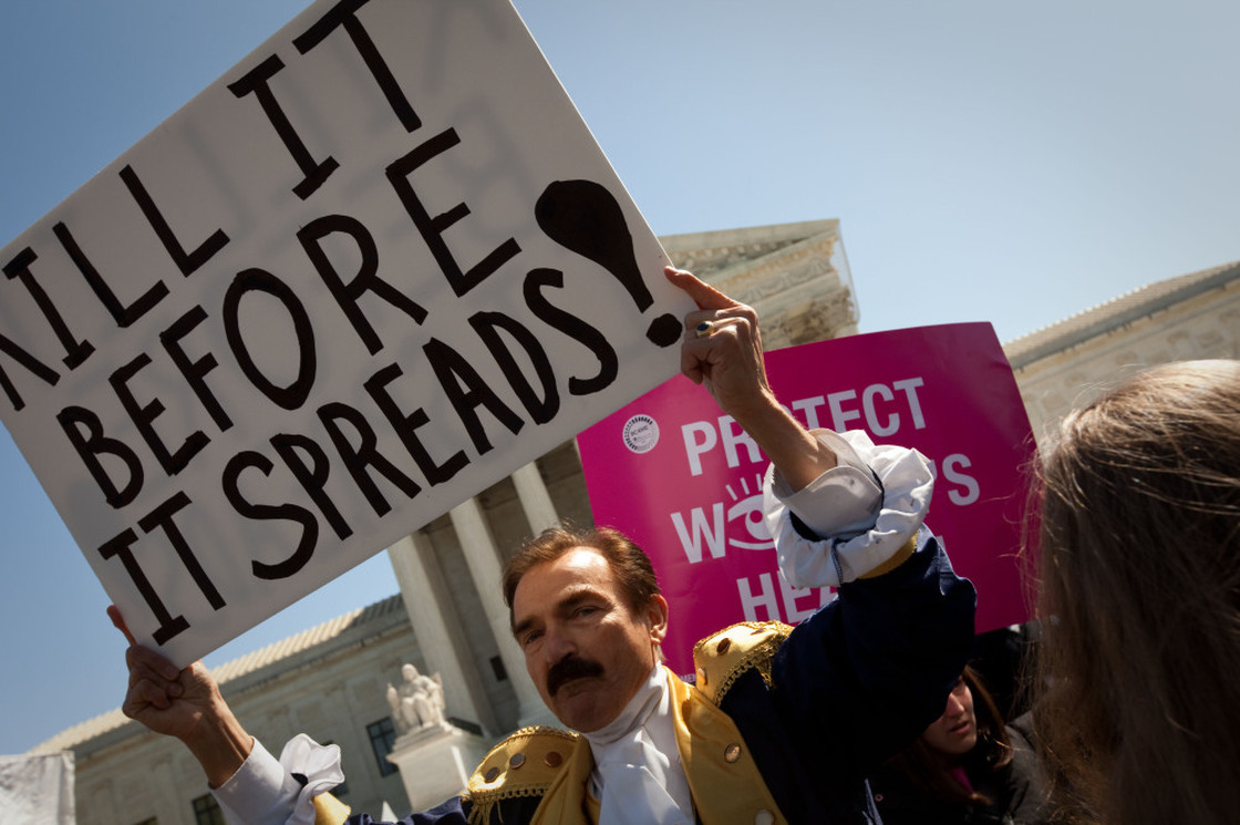 Opponents and supporters of President Obama's health care overhaul rallied outside the Supreme Court on Tuesday. Bob Mason shows support for the Tea Party by dressing in costume as one of the Founding Fathers.
